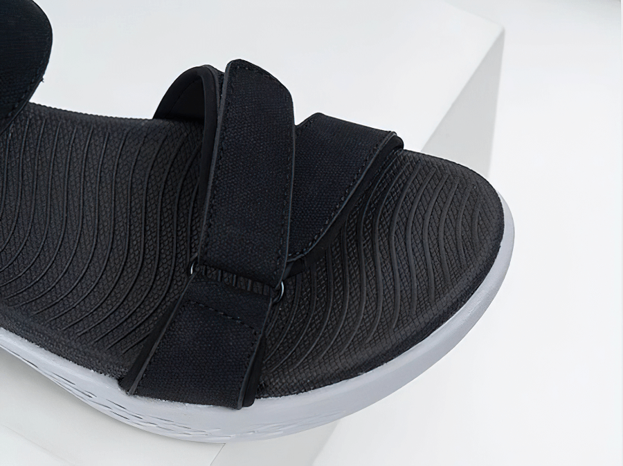 Close-up of black soft sole wedge open sandal with hook & loop closure, perfect for active women seeking comfort and style.